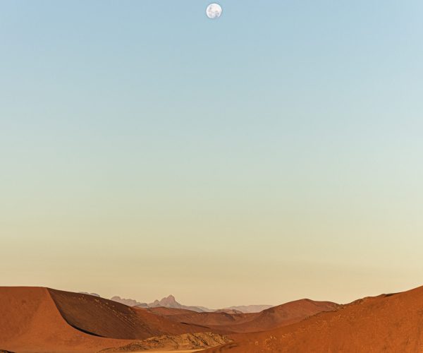 Namib-Naukluft National Park Landscape with Red Desert Sand, Massive Dunes, and Distant Mountains, Under the Glow of a Full Moon - A Breathtaking Alien-Like Scene